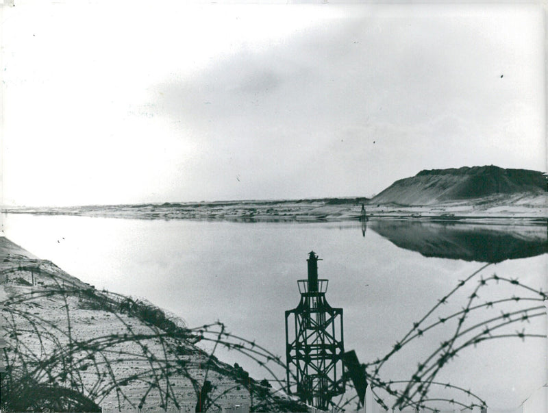 A view of the Suez Canal from the East Bank, showing part of the Israeli Bar Lev line of defences. The East Bank was recaptured by the Egyptians in October 1973. - Vintage Photograph