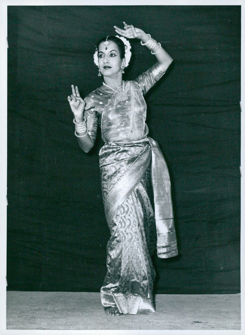 An Indian classical dancer conveys emotions of love and anguish through her performance as she looks in anticipation of her lover's arrival. - Vintage Photograph