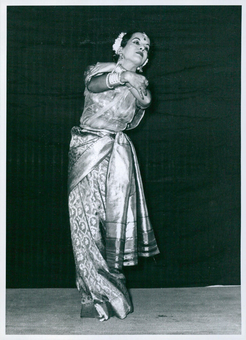 A woman in Indian classical dancing conveys the emotion of love as she performs the "Swadheenabhartrika" dance. - Vintage Photograph