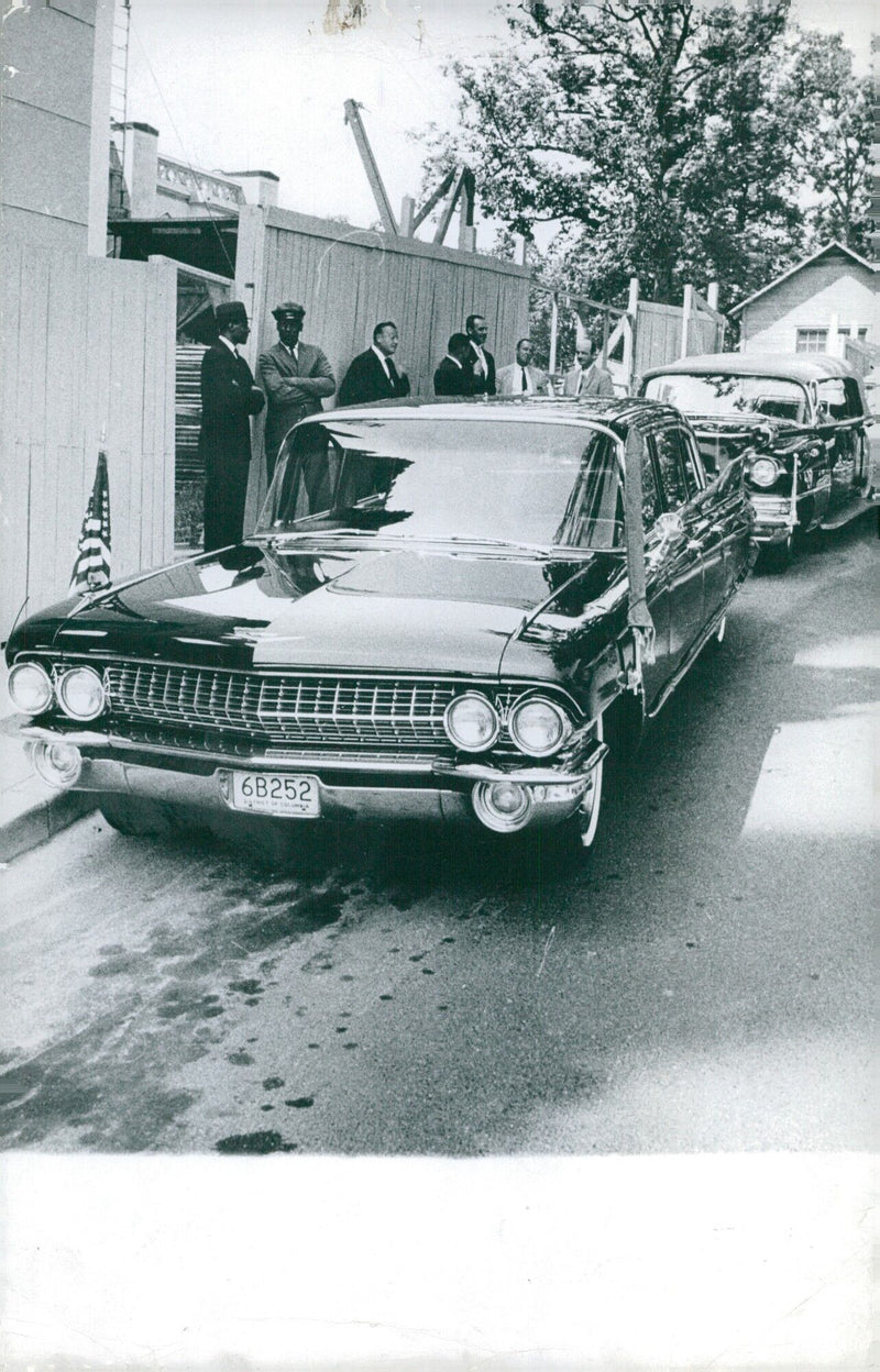 Parisians admire a 1961 Cadillac driven by Johnson on the Avenue Frochot in the 9th district of Paris on December 22, 1961. - Vintage Photograph