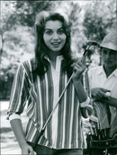 Actress Rosanna Schiaffino enjoys a game of golf in Venice while her film, La Sfida, premieres. - Vintage Photograph