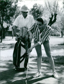 Actress Rosanna Schiaffino expertly putst the ball into the hole at the Lido in Venice after attending the Film Festival. - Vintage Photograph