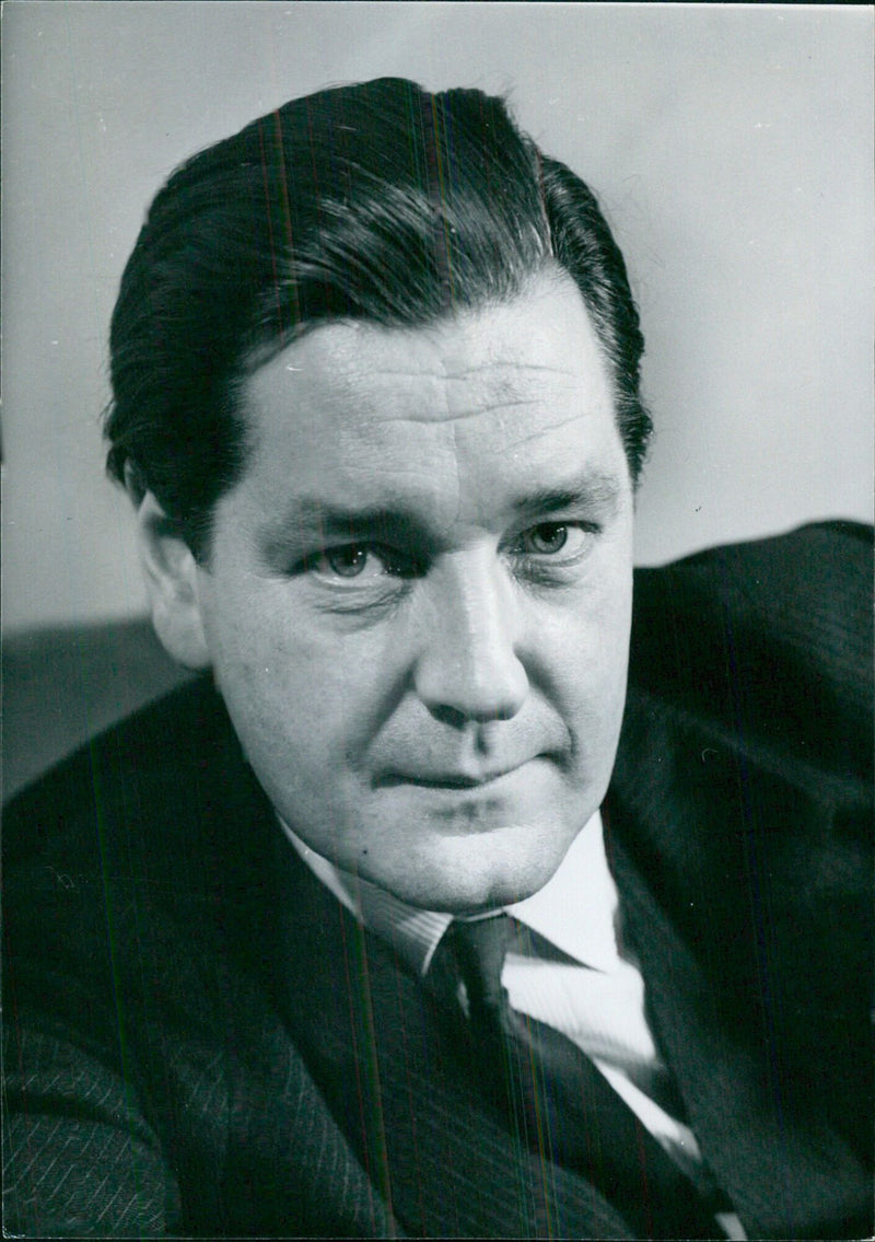 British Politicians Charles Anthony Crosland, M.P. and Economic Secretary of the Treasury, and Labour Member of Parliament for Grimsby since 1959, pose for a photograph at the Torsgat 21 in Stockholm, Sweden on October 21, 1964. - Vintage Photograph