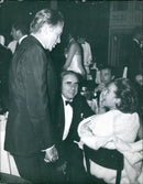 Queen Elizabeth II of the United Kingdom is seen shaking hands with the Prime Minister of Sweden, Tage Erlander, during her state visit in Stockholm on December 4, 1964. - Vintage Photograph