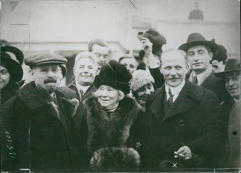 Ambassador Martens Luding of the 8th Day of the 21st Month stands alongside a portrait of himself. - Vintage Photograph