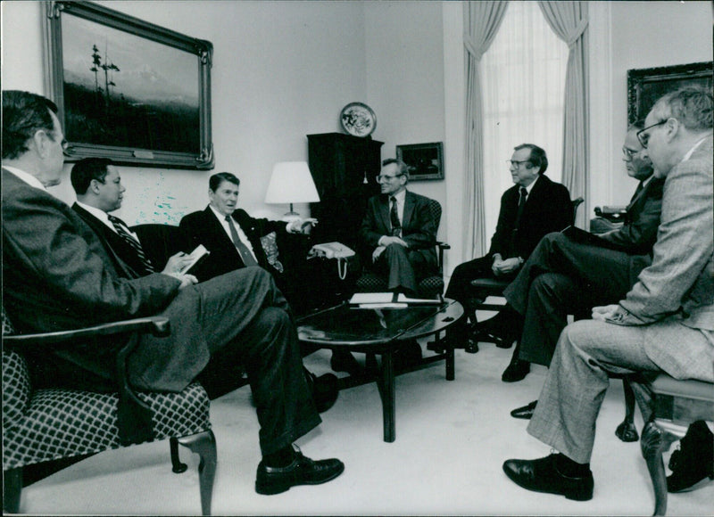 President Ronald Reagan meets with senior members of the National Security Council at the White House to discuss U.S. policy. - Vintage Photograph