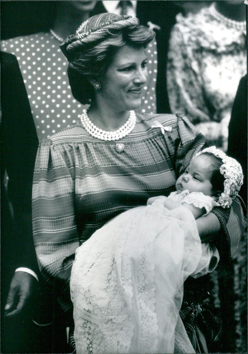 Queen Anne-Marie of Greece holds her two-month-old son, Prince Philippos, after his christening in London in July 1985. - Vintage Photograph