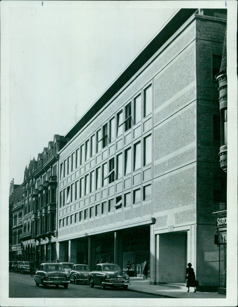 A group of police officers stand in front of a house on Tuesday, October 29, 1957. - Vintage Photograph