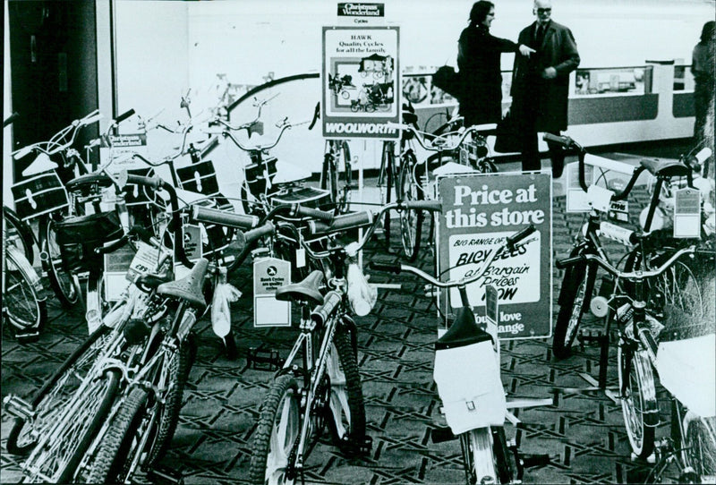 Customers browsing a variety of bicycles at a store. - Vintage Photograph