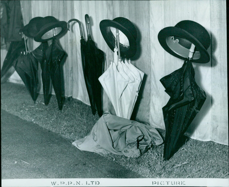 Umbrella takes a break at Oxford Society annual meeting and garden party. - Vintage Photograph