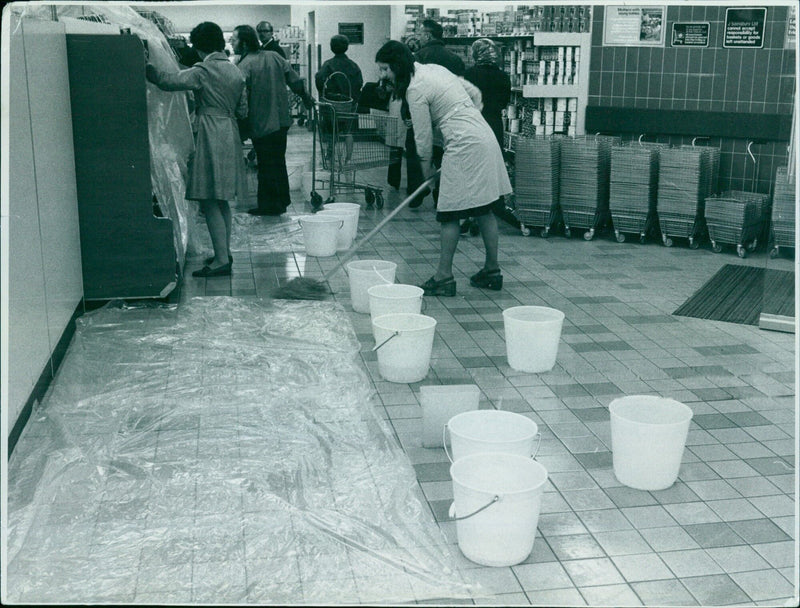 Employees of Sainsbury's Westgate Centre in Oxford attempt to contain a leak in the ceiling. - Vintage Photograph