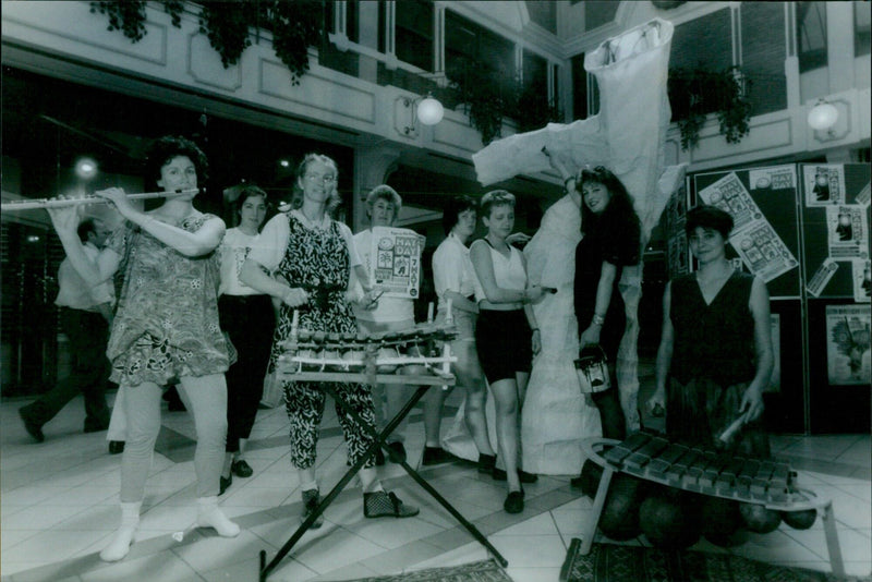 An Afro-Chinese musical trio plays with local students at the Westgate Centre to promote the Fun in the Parks event. - Vintage Photograph