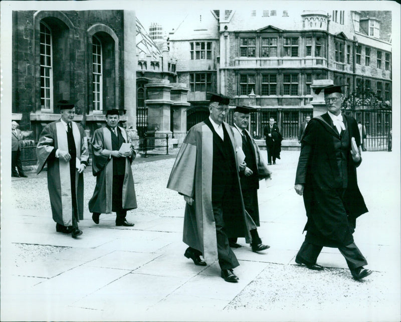 Four honorary degree recipients walk in the Sheldonian Theatre during a graduation ceremony at the University of Oxford. - Vintage Photograph