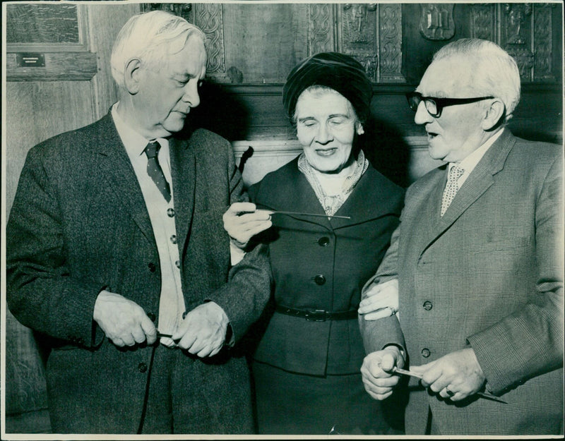 Three students examine a printout of a photo. - Vintage Photograph