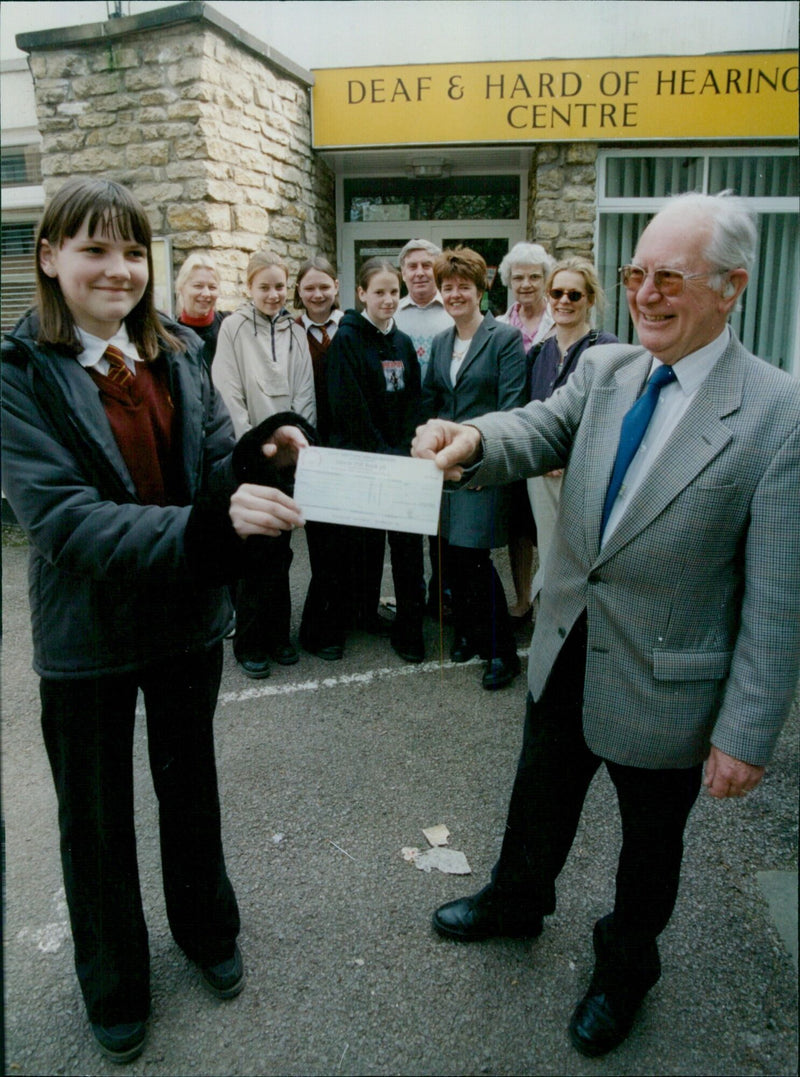 Claire Allsworth, 14, presents a donation to Deaf Centre Chairman Trevor Lawrence at a disco fundraiser put on by Matthew Arnold School year 7 and 8 students. - Vintage Photograph