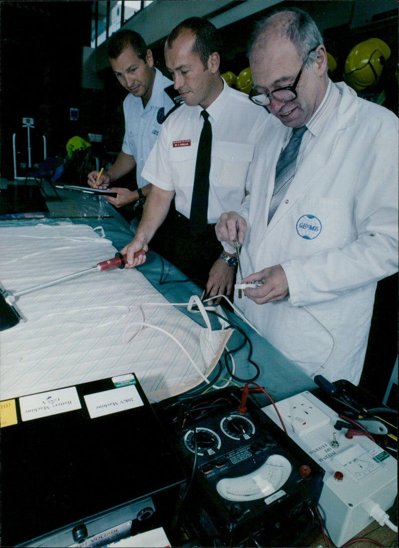 Fire service and Oxfordshire trading standards team test electric blankets for safety. - Vintage Photograph