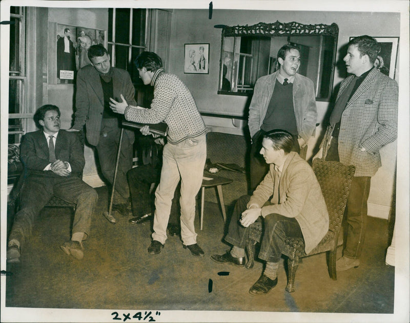 Producer Derek Goldby gives last-minute instructions to two members of the Cambridge University Mummers. - Vintage Photograph