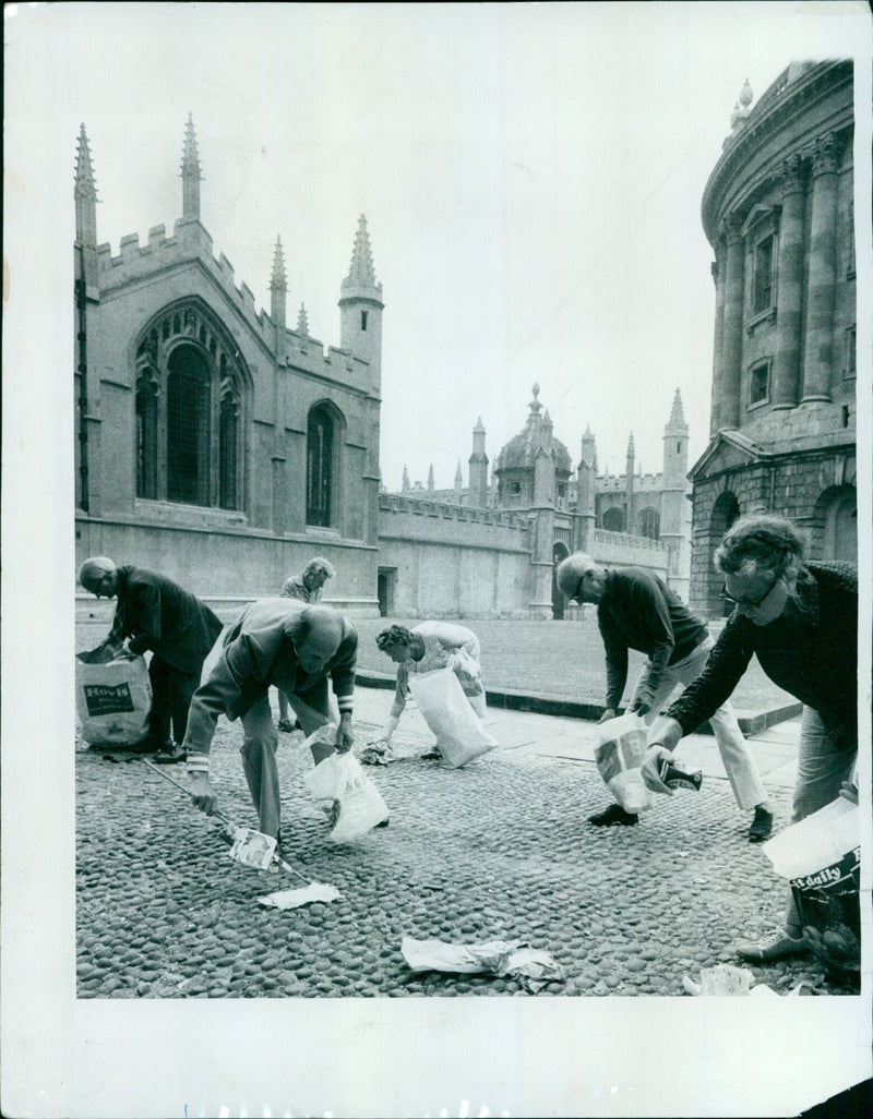 A family walks past a public mural depicting a scene from the Hovis Mithe & G. Daily paper in Oxford, UK, on July 31, 1975. - Vintage Photograph