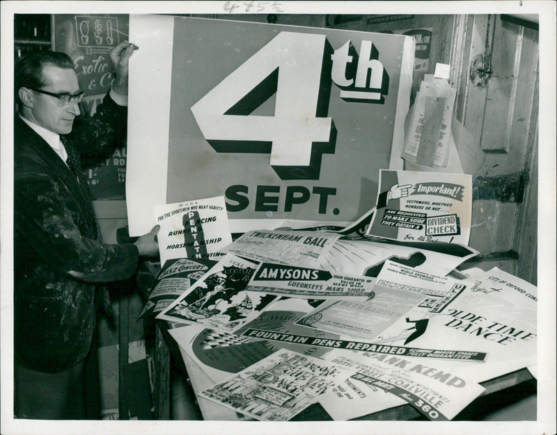 Variety of work is displayed in a silk screen printing studio. - Vintage Photograph