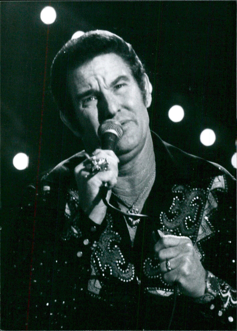 American country singer Freddie Hart is seen performing with his latest album "Super Kind of Woman" at a concert. - Vintage Photograph