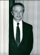 A man and woman are seen interacting with each other while standing in a busy city street in Stockholm, Sweden. - Vintage Photograph