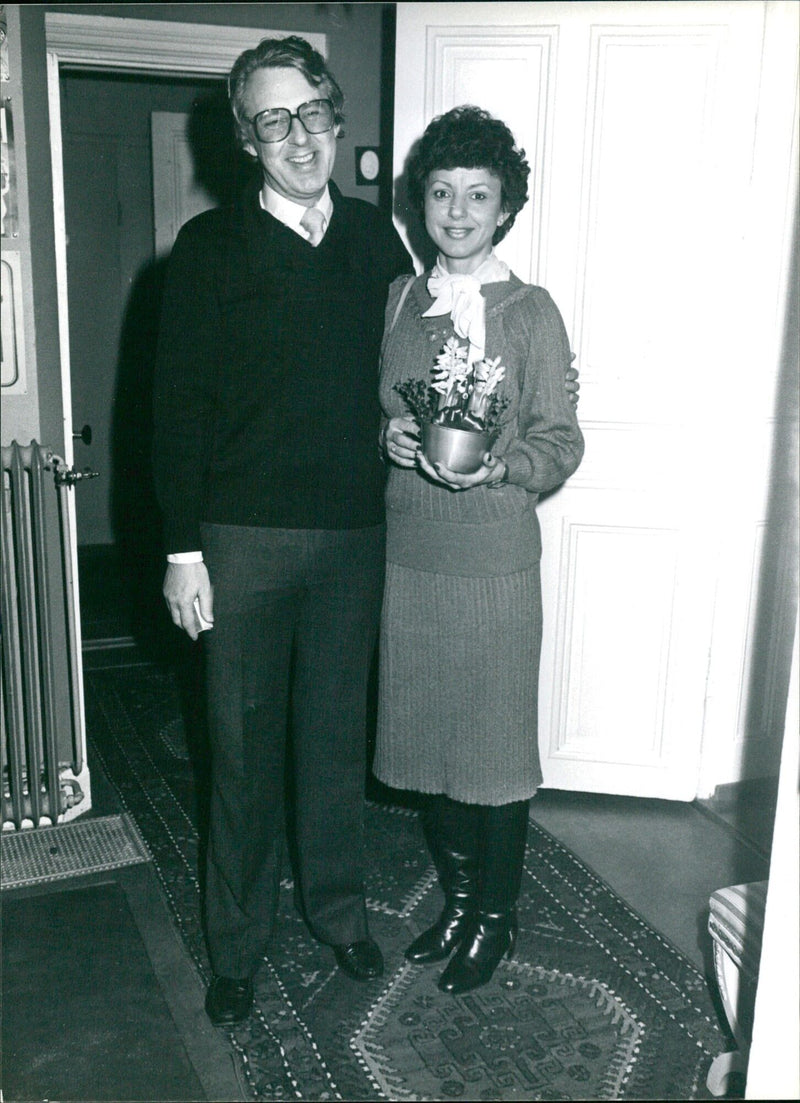 Two people embrace in a warm hug outside a Swedish cafe. - Vintage Photograph