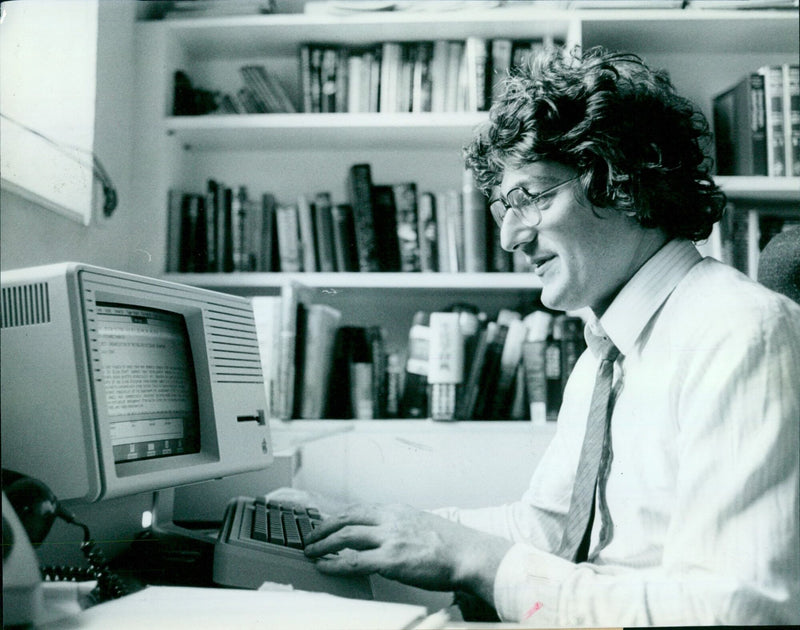 Mr Richard Charkin, OUP's youngest leader, is embracing the new age of technology as he works at his desk with a computer terminal. - Vintage Photograph