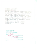 British writer Sarah Harrison poses with her upcoming novel, "The Flowers of the Field," which will be released in April 1980. - Vintage Photograph