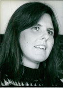 British writer Sarah Harrison poses with her upcoming novel, "The Flowers of the Field," which will be released in April 1980. - Vintage Photograph