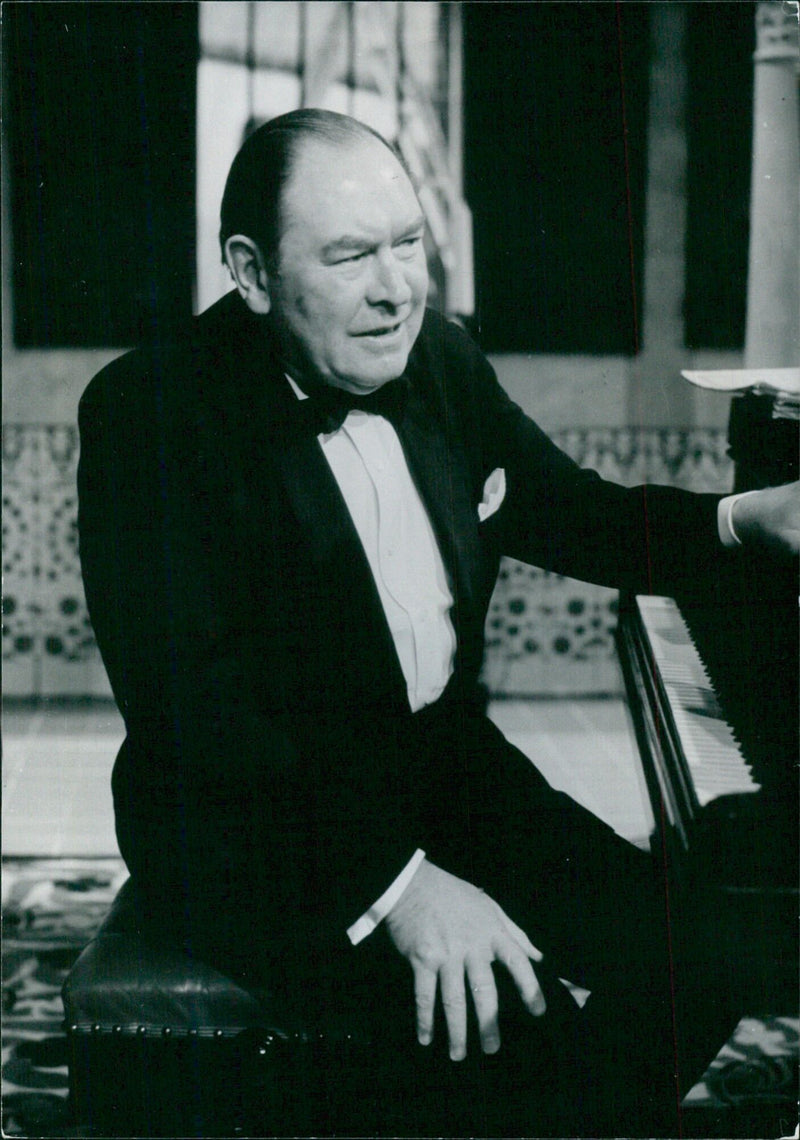 British pianist Gerald Moore poses for a portrait in 1967 following his retirement from the concert stage. - Vintage Photograph