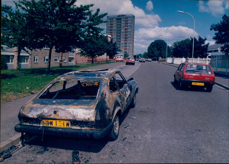 A burnt out Ford Capri parked on a street in Oxford. - Vintage Photograph