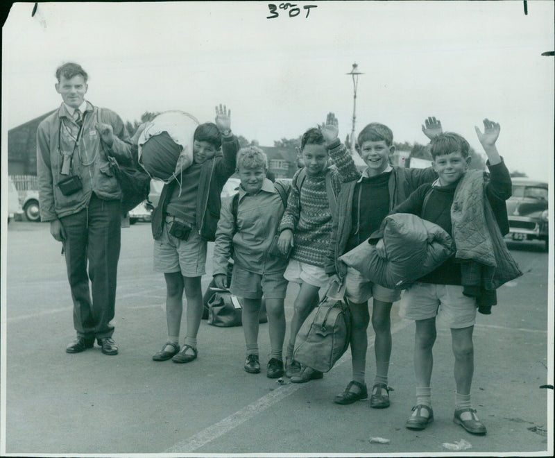 Young explorers from Oxford explain their plans for an upcoming expedition. - Vintage Photograph