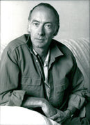 British poet Roger McGough is seen in 1984 while achieving fame as a member of the pop group Scaffold. Photo taken by Tara Heinemann at Camera Press London. - Vintage Photograph