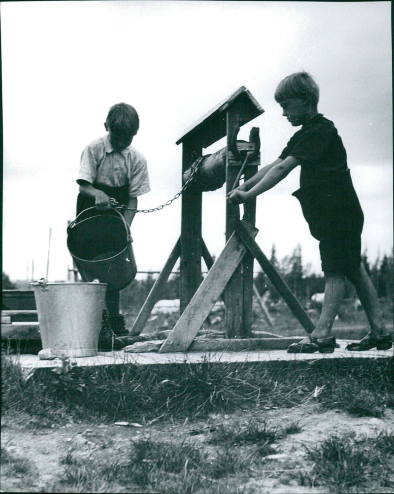 Boys fetching water from a well Sweden 1950´s - Vintage Photograph