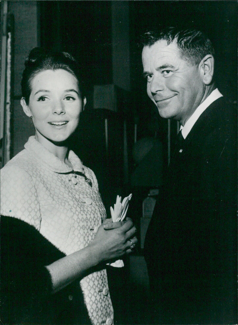 Hollywood couple Mr. and Mrs. Glenn Ford pose for the camera in London on January 24, 1987. - Vintage Photograph