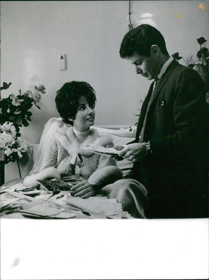 Eddie Fisher and Liz Tayler are seen celebrating their 27th wedding anniversary in 1961. - Vintage Photograph