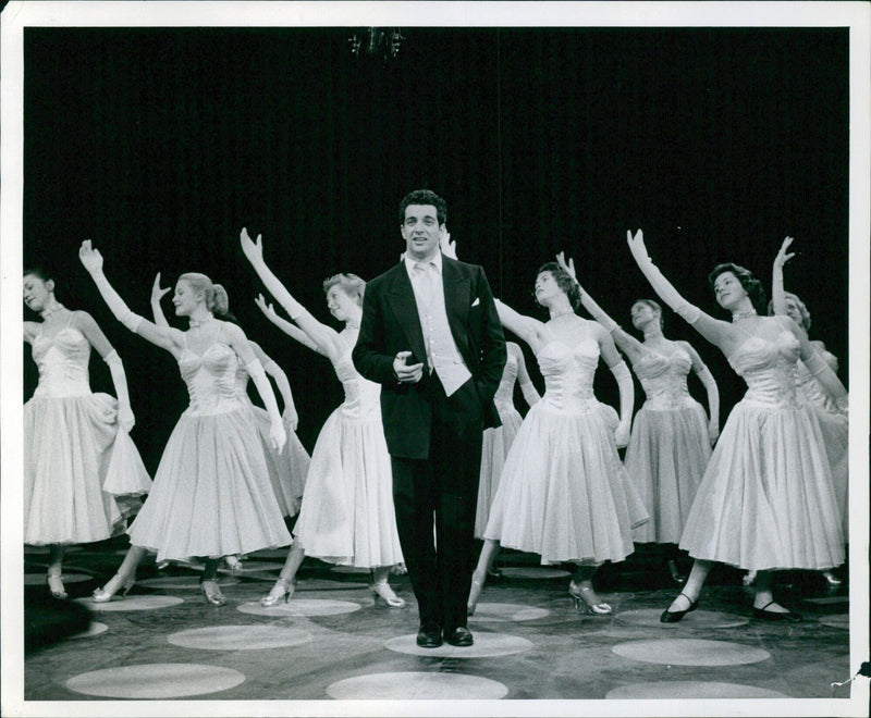 Frankie Vaughan, a passionate performer, exudes energy on stage during a performance in Pully, Switzerland. - Vintage Photograph