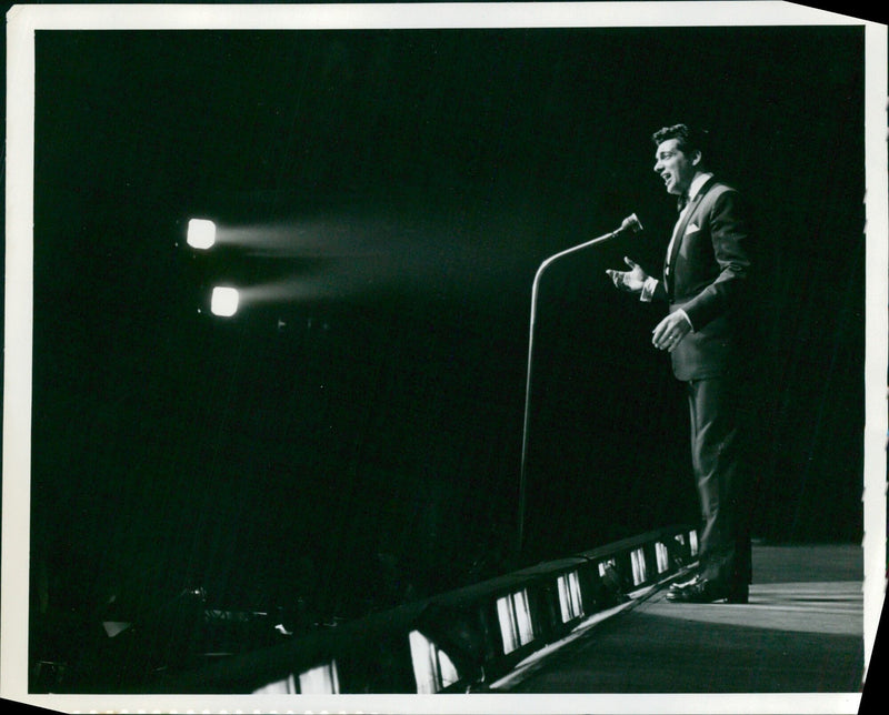 British singer Frankie Vaughan poses for a photograph in 1965 at the height of his fame and popularity. - Vintage Photograph