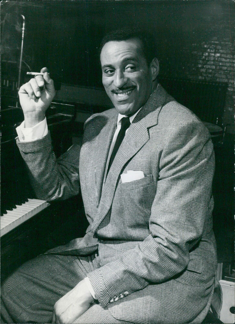 Ray Ellington, leader of the Ray Ellington Quartet, poses for the camera at a press event in London. - Vintage Photograph