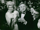 Kirk Douglas and Anne Buydoux attend the 10th Cannes Film Festival in 1953. - Vintage Photograph