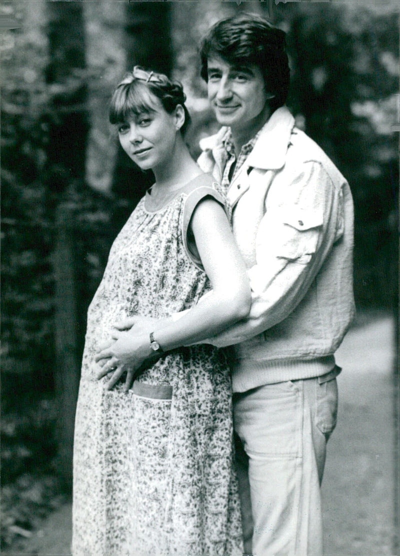 British actress Jenny Agutter anticipates her new role in the film "Sweet William" as she is joined by American co-star Sam Waterson and generous padding to create the expectant illusion. - Vintage Photograph