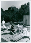 Teenage models take a break from their lessons and relax in the pool at Glamour Farm, 1962. - Vintage Photograph