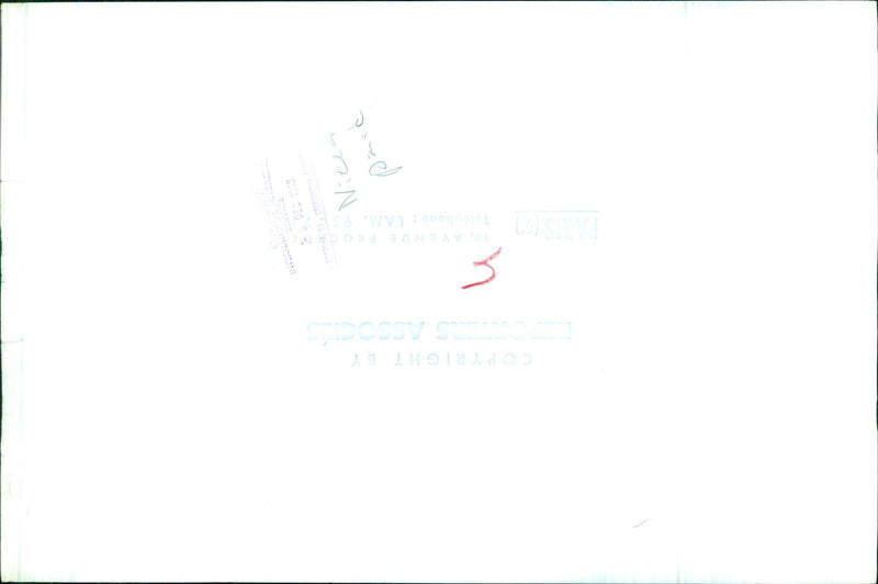 Two people stand in front of a building, one holding a sign that reads "10, Avenue Fro Paris (7)" in Arabic. - Vintage Photograph