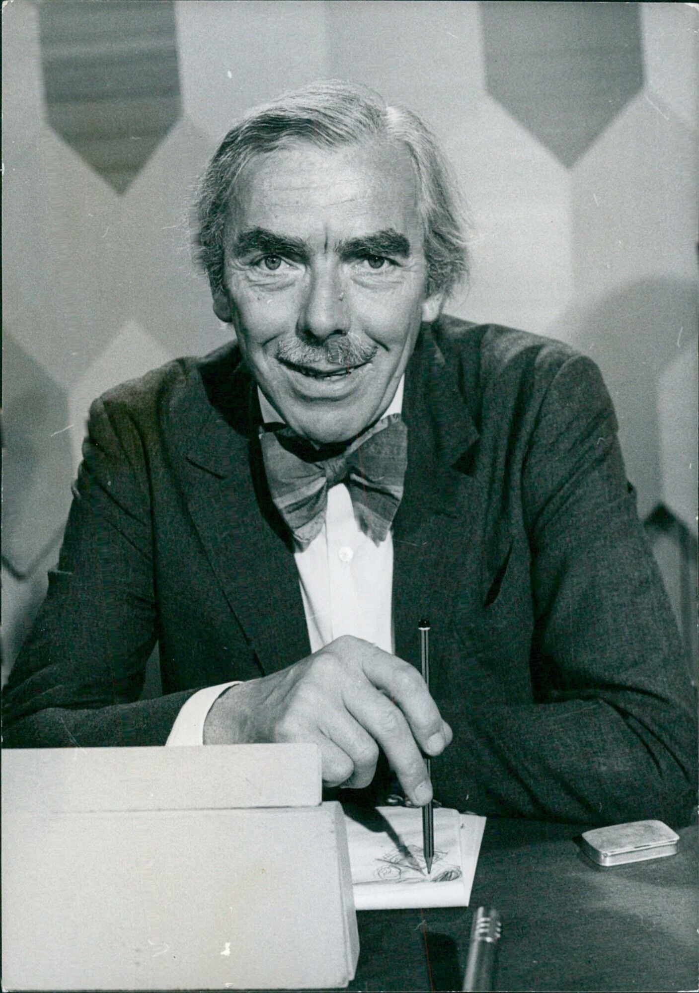 British broadcasters Frank Muir and Denis Norden pose for a portrait d