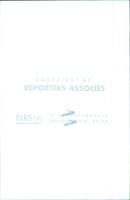 A man and woman in Paris, France, are seen walking down the street on a sunny day. - Vintage Photograph