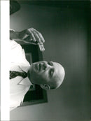 A group of people gather outside the Sveam 85 building in Stockholm, Sweden on January 6, 1961. - Vintage Photograph