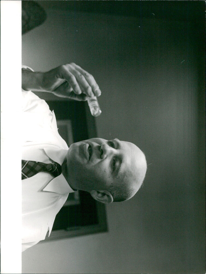 A group of people gather outside the Sveam 85 building in Stockholm, Sweden on January 6, 1961. - Vintage Photograph