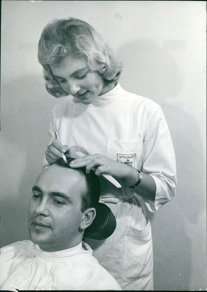 Yana performs a hair treatment on Sakis using a Bio-Regenerative Capillary product at the MONDIAL-PRESSE beauty salon in Paris. - Vintage Photograph