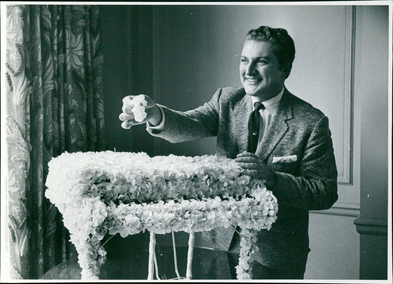 Musician Liberace performs on stage in front of an adoring crowd. - Vintage Photograph