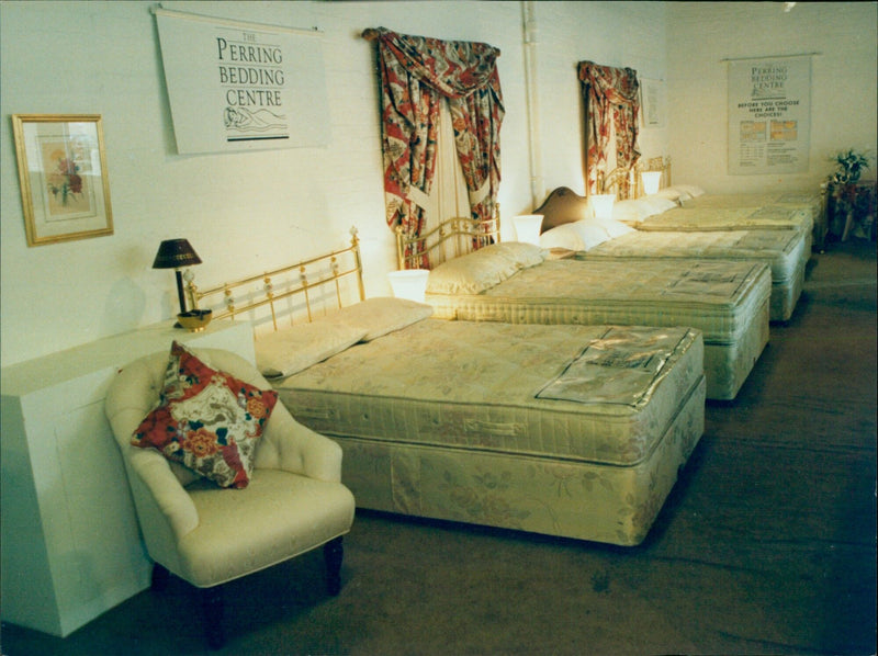 Customers browse a variety of bedding options at a store in Oxford. - Vintage Photograph